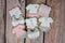 Decorated homemade Baby Shower cookies for a girl theme, decorated in royal icing in pink, gray and white colors on a wooden backg