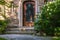 The decorated with iron vine front door of a house in upscale neighborhood