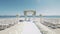 Decorated luxury wedding ceremony place at the beach white sand beautiful sea and sky with White empty chairs and arch decorated