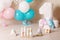 Decorated number 1 for a birthday.  Happy birthday one year for twins. White, pink, blue colors. Wood toys  of natural material