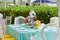 Decorated party table setting with bird house and flower arrangements in polka dots jars