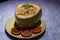 Decorated platter dinner with coconut shell fitted rice and sauce served in a black plate on a table in touristic visit in Bali