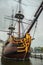 Decorated prow and masts of the sailboat replica moored next to the National Maritime Museum in Amsterdam.