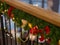 Decorated railing with a green Christmas tree, multi-colored bows and balls.