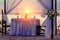 Decorated for a romantic dinner table on the sandy beach. Against the backdrop of sunset, yachts and mountains