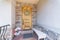 Decorated small porch of a house with stone veneer sidings and railings