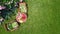 Decorated table with bread, strawberry and fruits in beautiful summer rose garden, aerial top view of romantic date table food