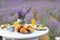 Decorated table with food in lavender field.