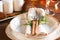 Decorated Thanksgiving or New Year table setting among white candles and winter decor.