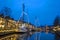 Decorated traditional boats in the harbor from Dokkum in the Netherlands at christmas at unset