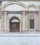 Decorated Window and wooden ornate door over white marble decorated wall