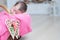 Decorated wooden hearts on basket on focus, newborn baby girl sleeping in basket, lying in pink blanket, cute child, daughter