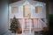 Decorated zone for Christmas. The facade of a white wooden house with stairs, swings, tree, decorated for the New Year