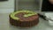 Decorating chocolate cake with kiwi. Placing kiwi in top of the cake.