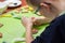 Decorating cinnamon cookies by a child. The boy`s hands form a face of colored icing squeezed out of tubes. Unaddressed biscuits i