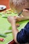 Decorating cinnamon cookies by a child. The boy`s hands form a face of colored icing squeezed out of tubes. Unaddressed biscuits i