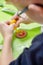 Decorating cinnamon cookies by a child. The boy`s hands form a face of colored icing squeezed out of tubes. Unaddressed biscuits i