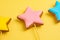 Decorating desserts. Colorful glazing cookies close up on a yellow background. Cake decorating tools. Confectionery