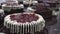 Decorating and making chocolate biscuit cakes with fresh cherry berries in production. Trot`s decoration with cream