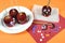 Decorating red toffee apples with funny crazy smiling faces for Halloween