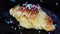 Decorating sweet croissant with colorful crumbs