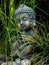 Decoration buddha statue little in a garden outdoor covered with grass