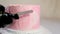 Decoration of a cake for a family christening pink cake with footprints of small child on top of angel wings and baby in