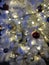 Decoration for Christmas tree hang on tinsel. Christmas decorations concept. Ball with ornaments hang on shimmering