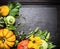 Decoration of colored pumpkins of different varieties with stems and leaves, autumn background