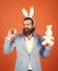 decoration easter egg. male funny egg hunt. bearded man in formalwear and hare ears. elegant businessman wear elegant