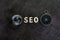Decoration globe, alphabet SEO and compass on dark cement chalkboard background using as SEO Search engine optimization concept