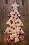 Decoration: handmade carved christmas tree with red miniatures.