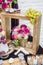 Decoration with pink, white and red flowers in golden wooden frame. Wedding decor with grapes and cookies. Fresh roses