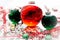 Decoration with red fluid filled Christmas ornament ball and two green filled ornament balls surrounded by a red Have Yourself A M