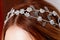 Decoration of silver beading on the girl`s hair. Close