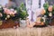 Decoration of a wedding table with a composition of flowers in wooden pots, a ceramic bird, candles and a wooden slice. close up