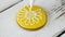 Decoration of yellow cookie with white flower.