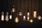 Decorative antique Edison style light bulbs, different shapes of retro lamps on dark background. Cafe or restaurant decoration