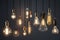 Decorative antique Edison style light bulbs, different shapes of retro lamps on dark background. Cafe or restaurant decoration