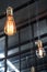 decorative antique edison style light bulbs with factory materials background.