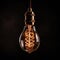 Decorative Antique Retro Edison Light Bulb on Dark Background. Generative ai