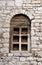 Decorative antique stone window built into the stone wall