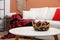 Decorative antler bowl with apples and pine cones in living room interior inspired by autumn colors