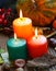 Decorative autumn candles burning with pumpkins and decorations