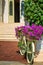 Decorative bike with flowers standing in front of the building