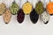 Decorative border of assortment pulses beans in spoons with copy space on white wood background.