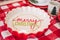 Decorative bowl in red and white with the inscription merry christmas focusing the camera on the