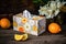 Decorative box of tissues and fresh oranges on a rustic table