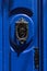 Decorative bronze door handle on a blue painted door. Malta