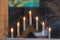 Decorative candlestick with burning candles on the window